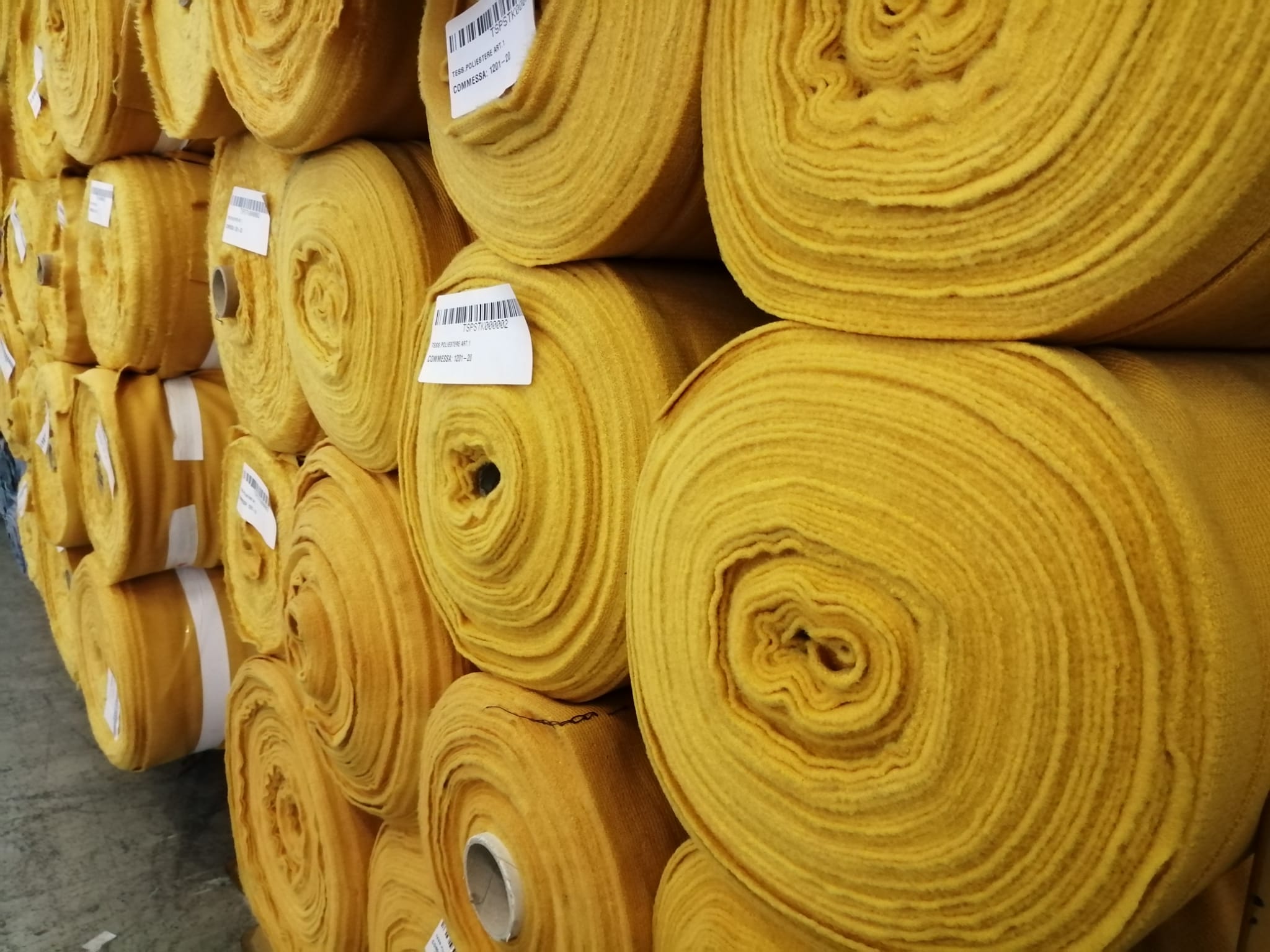 Yellow coat fabrics on stock rolls